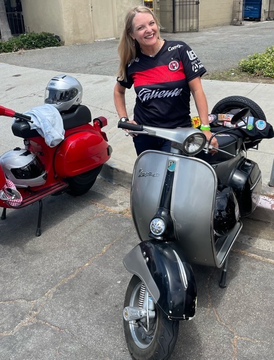Scooterella founder Kate Dana stands next to a 1966 Vespa 150 Sprint scooter in Long Beach, CA, photo ©Kate Dana