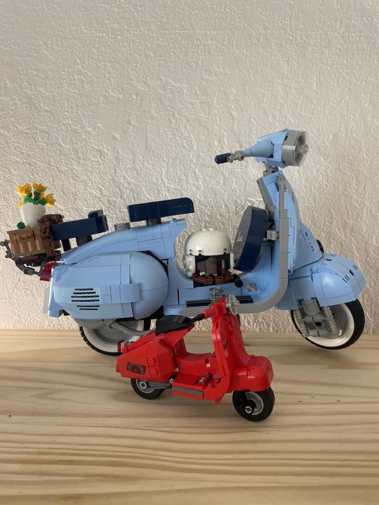 A large light blue and a small red Vespa scooter, both made with Legos, photo ©Kate Dana