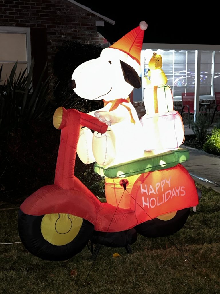 An inflatable holiday lawn decoration of Snoopy on a Vespa scooter, photo ©Kate Dana