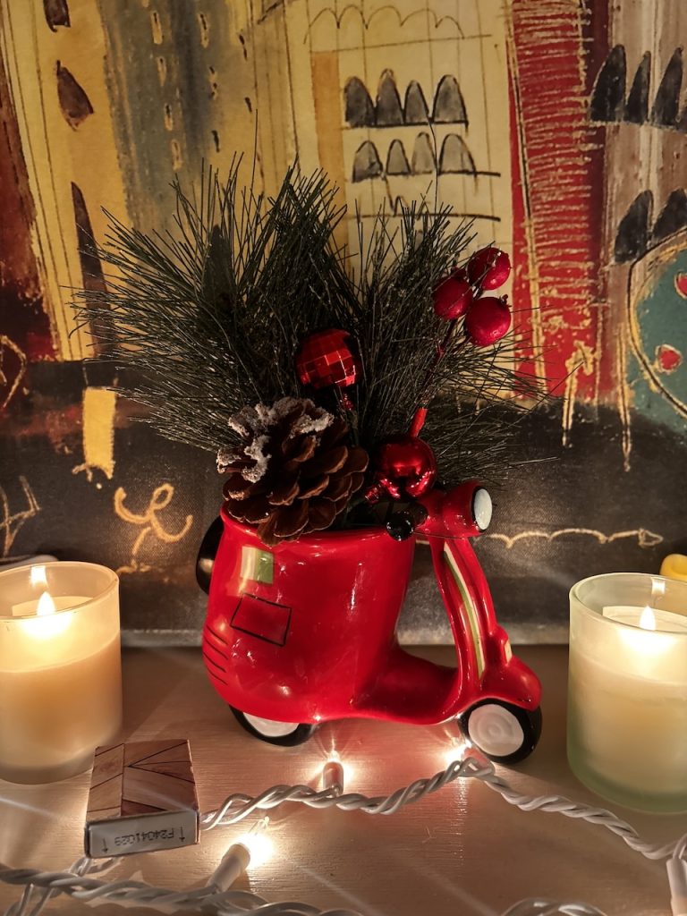 A red coffee mug deccorated for the holidays with green holly photo ©Kate Dana